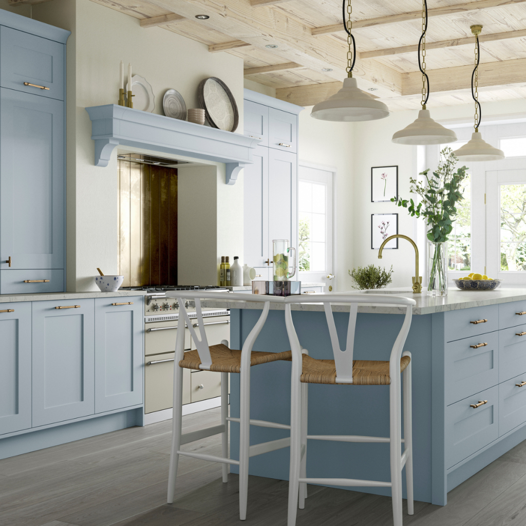 Traditional pastel blue kitchens in Reigate with island seating and timber ceiling details